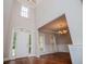 Elegant foyer with soaring ceilings, hardwood floors, and wainscoting leading to a dining room at 5995 Azalea Ridge Dr, Douglasville, GA 30135