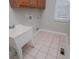 Functional laundry room with ample cabinet space and tiled floor for easy maintenance at 5995 Azalea Ridge Dr, Douglasville, GA 30135
