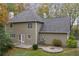 This backyard features a stone patio and is surrounded by mature trees at 7165 Jonsway, Cumming, GA 30041