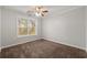 Clean and airy bedroom with soft carpeting, a ceiling fan, and a well-lit atmosphere at 7165 Jonsway, Cumming, GA 30041