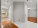Bright hallway with hardwood and tile flooring, offering seamless access to various rooms at 7165 Jonsway, Cumming, GA 30041