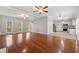 Open-concept living space with windows, hardwood floors and a connected kitchen area at 7165 Jonsway, Cumming, GA 30041