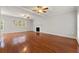 Expansive living room with hardwood floors, a fireplace, and abundant natural light at 7165 Jonsway, Cumming, GA 30041