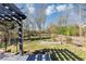 View of the backyard with a dark pergola and multiple garden beds at , Suwanee, GA 30024