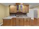 Charming bar area with wooden cabinets, tile backsplash, sink and light countertops at , Suwanee, GA 30024