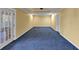 Spacious basement with blue carpet, yellow walls, recessed lights, and a door to the outside at , Suwanee, GA 30024