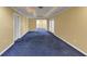 Bright basement with blue carpeting, recessed lights, yellow walls, and white trim at , Suwanee, GA 30024