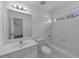 Bright bathroom with a large mirror over the sink and a tiled tub at , Suwanee, GA 30024