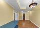 Bonus room featuring laminate wood flooring, yellow walls, and unique lighting fixtures at , Suwanee, GA 30024