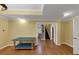 Bonus room featuring laminate wood flooring, yellow walls, and access to other spaces at , Suwanee, GA 30024