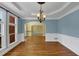Elegant dining room boasts hardwood floors, detailed wainscoting, and a decorative chandelier fixture at , Suwanee, GA 30024