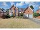 Charming two-story brick home featuring an attached two-car garage and manicured landscaping at , Suwanee, GA 30024