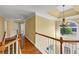 Bright hallway with hardwood floors, stairs, and a view from the windows at , Suwanee, GA 30024