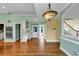 Light-filled kitchen area featuring hardwood floors, double ovens, light-green walls, and access to other living areas at , Suwanee, GA 30024