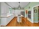 Modern kitchen with white cabinets, stainless steel appliances, hardwood floors, and an island cooktop at , Suwanee, GA 30024