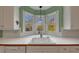 Bright kitchen featuring a sink with large windows and white cabinets for lots of natural light at , Suwanee, GA 30024