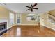 Bright living room with fireplace, hardwood floors, and an open view to the kitchen and staircase at , Suwanee, GA 30024