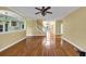 Open-concept living room with hardwood floors, staircase, and a view to the kitchen and front entrance at , Suwanee, GA 30024