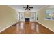 Spacious living room with natural light, featuring hardwood floors, fireplace, and a ceiling fan at , Suwanee, GA 30024