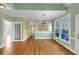 Open living room showcasing hardwood floors, light-green walls, and a view into the adjacent dining and living areas at , Suwanee, GA 30024