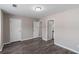Bedroom featuring three doors, wood-look floors, and neutral paint at 310 Ashigan St, Union City, GA 30291