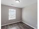 A light and airy bedroom with wood-look flooring and ample natural light at 310 Ashigan St, Union City, GA 30291