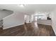 Open-concept living space with stairs, half bath, wood-look floors, and kitchen access at 310 Ashigan St, Union City, GA 30291
