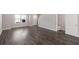 Spacious living room with wood-look floors, neutral paint, and ample natural light at 310 Ashigan St, Union City, GA 30291