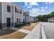 Street view of townhomes with sidewalks, landscaping, and a row of attractive facades at 310 Ashigan St, Union City, GA 30291