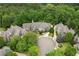 Expansive aerial view of a luxury home surrounded by lush greenery, showcasing its grand scale and meticulous landscaping at 5119 Greythorne Ln, Marietta, GA 30068