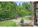 Lush backyard with a stone fountain, manicured lawn, and mature trees, offering a serene outdoor living space at 5119 Greythorne Ln, Marietta, GA 30068