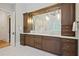 Elegant bathroom with wood cabinets, dual sinks, a large mirror, and modern pendant lighting at 5119 Greythorne Ln, Marietta, GA 30068
