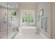Modern bathroom featuring a standalone tub, glass-enclosed shower, and bright natural light at 5119 Greythorne Ln, Marietta, GA 30068