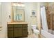 Traditional bathroom with olive vanity, tan countertop, and tiled shower-tub combination at 5119 Greythorne Ln, Marietta, GA 30068