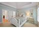 Bright bedroom with tray ceiling, white wood furniture, and multiple mirrors at 5119 Greythorne Ln, Marietta, GA 30068