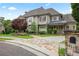 Beautiful two-story home with stone walkway, lush landscaping, and an American flag on the front porch at 5119 Greythorne Ln, Marietta, GA 30068