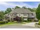 Stately home with stone accents, manicured lawn, and charming curb appeal in a lush, green neighborhood at 5119 Greythorne Ln, Marietta, GA 30068