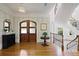 Grand foyer with hardwood floors, a curved staircase, and stylish lighting creates an inviting entrance at 5119 Greythorne Ln, Marietta, GA 30068