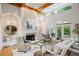 Elegant living room with high ceilings, exposed beams, a fireplace, and large windows for natural light at 5119 Greythorne Ln, Marietta, GA 30068