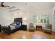 Spacious main bedroom with a tray ceiling, hardwood floors, and bright windows with shutters at 5119 Greythorne Ln, Marietta, GA 30068