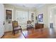 Spacious home office offering built-in shelving, hardwood floors, a window seat, and natural light at 5119 Greythorne Ln, Marietta, GA 30068