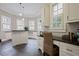 Brightly lit office space featuring white cabinetry, black countertops and desk space with a cozy chair at 5119 Greythorne Ln, Marietta, GA 30068