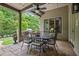 Outdoor patio features a ceiling fan, stone flooring, and outdoor seating with a view of landscaped backyard at 5119 Greythorne Ln, Marietta, GA 30068