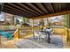 Spacious, covered back porch featuring a dining table set, outdoor seating and a wooden railing at 1377 Dorothy Dr, Decatur, GA 30030