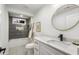 Bathroom with sleek vanity, round mirror, and tiled shower-tub combination at 1377 Dorothy Dr, Decatur, GA 30030
