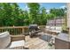 Spacious deck perfect for entertaining, complete with grill, patio furniture, and wooded view at 2237 Foley Park St, Snellville, GA 30078