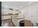 Open kitchen with stainless steel appliances, granite countertops, and wooden floors at 2237 Foley Park St, Snellville, GA 30078