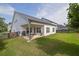 Back exterior of a home with a patio, grill, fenced-in yard, and green lawn at 5320 Coltman Dr, Cumming, GA 30028