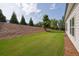 Manicured backyard featuring a lush lawn and mature trees at 5320 Coltman Dr, Cumming, GA 30028