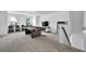 Finished basement with a pool table, several chairs, and a television in a bright and airy space at 5320 Coltman Dr, Cumming, GA 30028